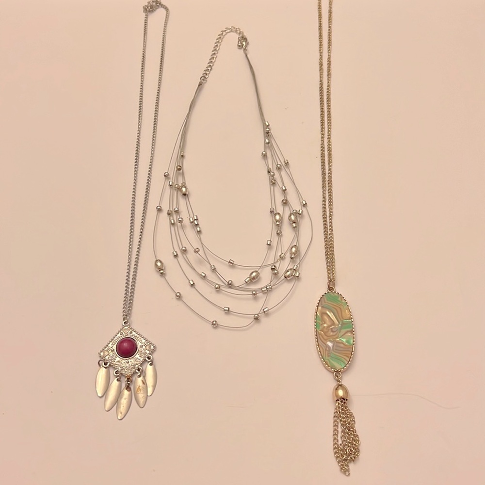 Girl’s costume jewelry bundle of three necklaces shown in photos.